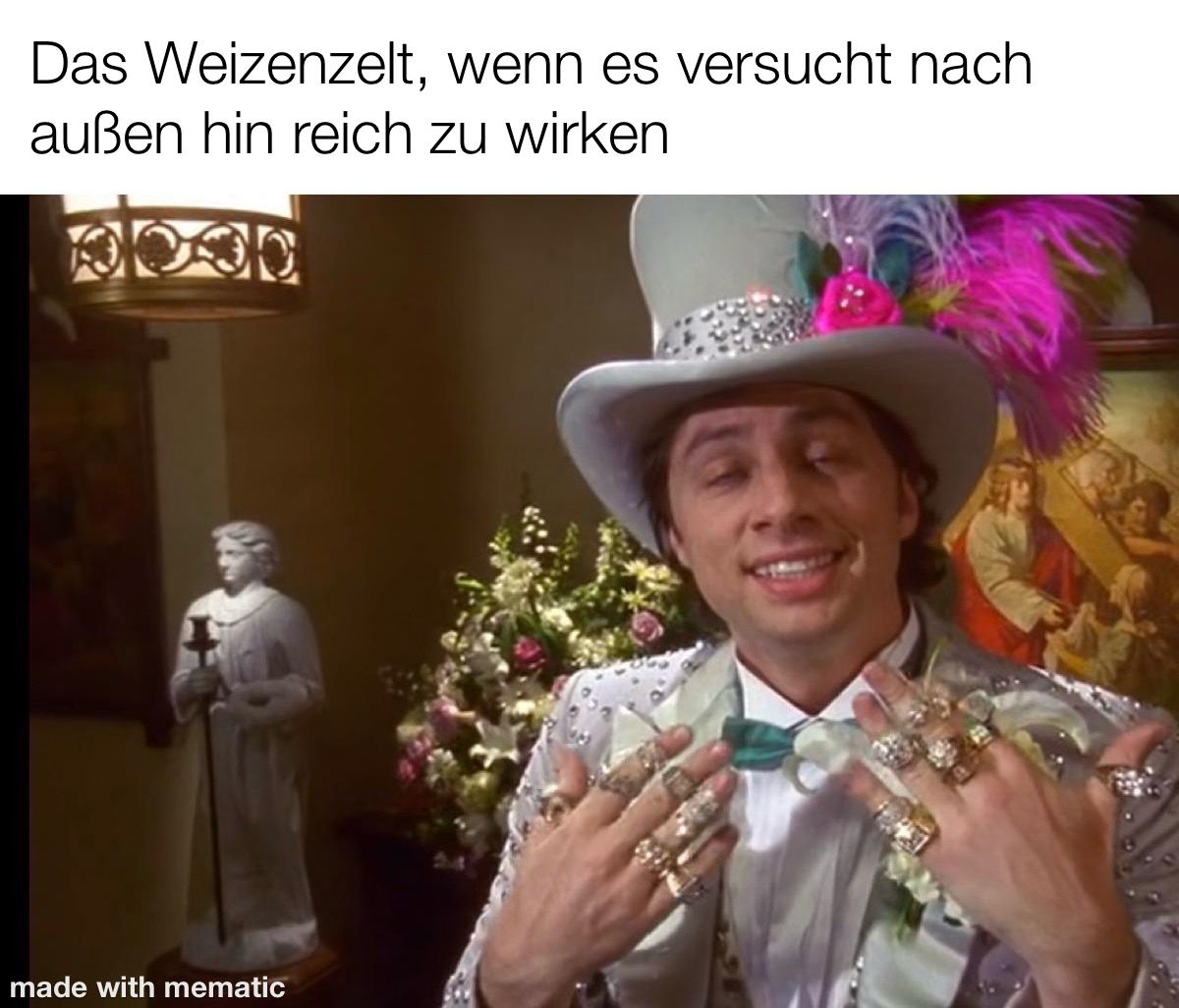 Überschrift: "Das Weizenzelt, wenn es versucht nach außen hin reich zu wirken" Bild: John Dorian aus der Serie Scrubs gekleidet in extravaganter mit diamanenbesetzter Kleidung